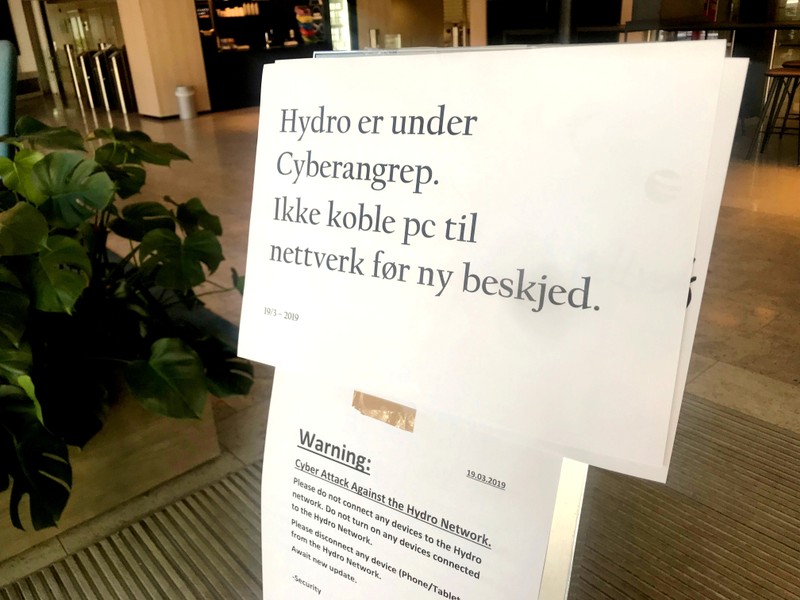 FILE PHOTO: A sign warning employees not to connect devices to the network in the wake of a cyber attack is seen at the headquarters of aluminum producer Norsk Hydro in Oslo