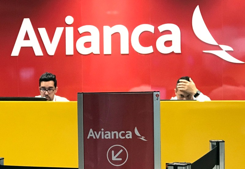 FILE PHOTO: Employees are seen at the desk of Avianca airlines at Afonso Pena International Airport in Sao Jose dos Pinhais