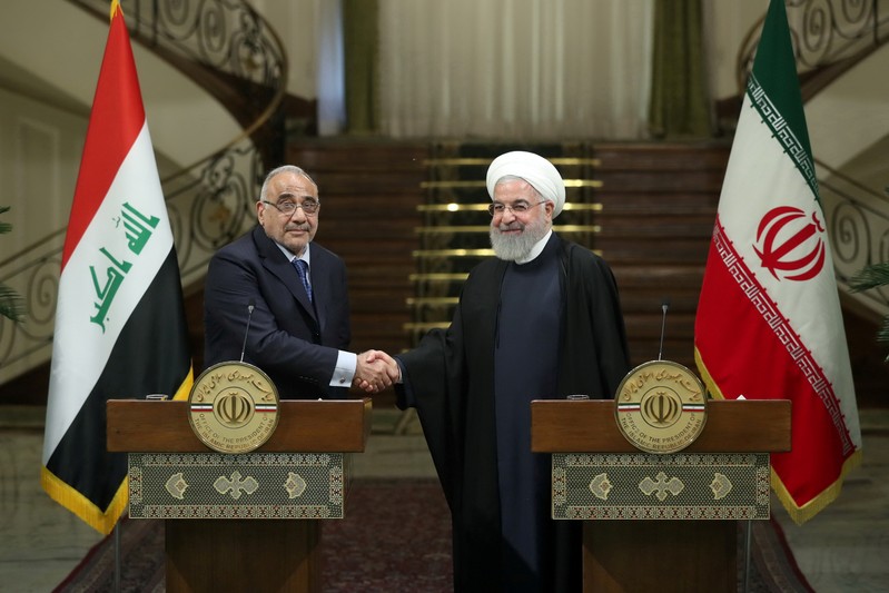 FILE PHOTO: Iranian President Hassan Rouhani shake hands with Iraq's Prime Minister Adel Abdul Mahdi during a news conference in Tehran