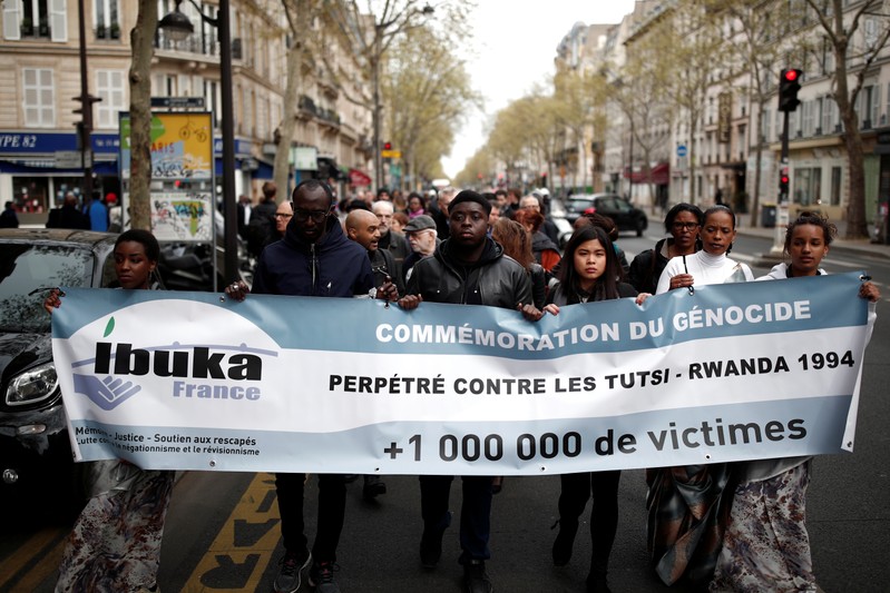 People take part in a silent walk to commemorate the 25th anniversary of the Rwandan genocide in Paris