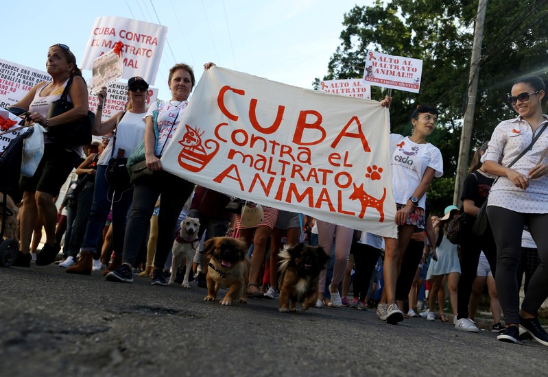 People carry a banner reading