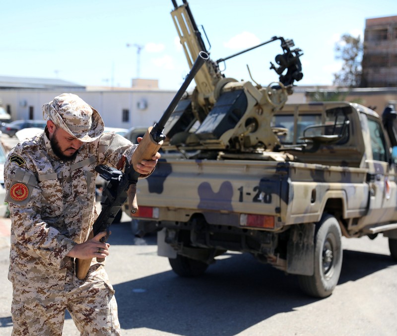 A Member of Misrata forces, under the protection of Tripoli's forces, prepares himself to go to the front line in Tripoli