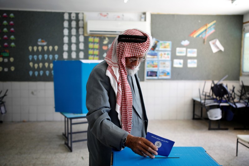 A Bedouin man casts his ballot as Israelis vote in a parliamentary election, at a polling station in the city of Rahat in Israel's southern Negev Desert