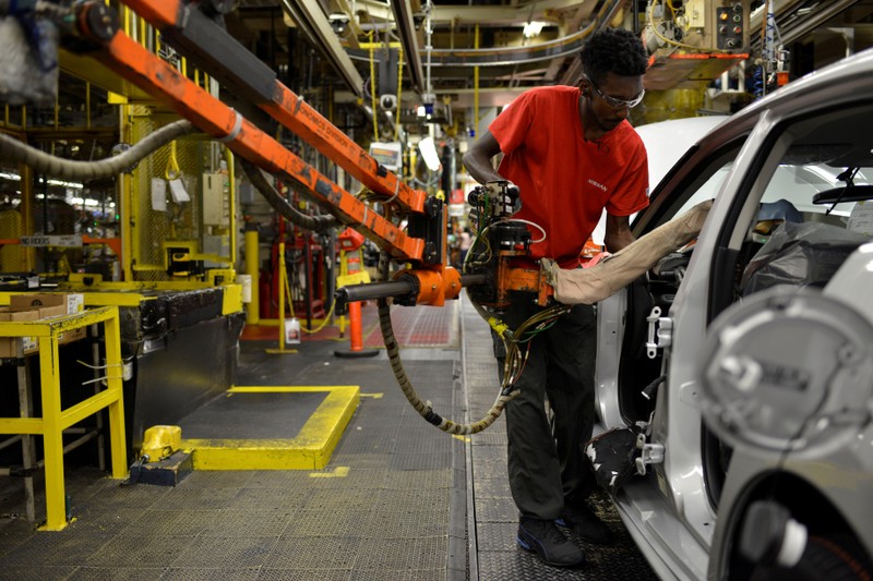 FILE PHOTO: A line worker installs the front seats on the flex line at Nissan Motor Co's automobile manufacturing plant in Smyrna Tennessee