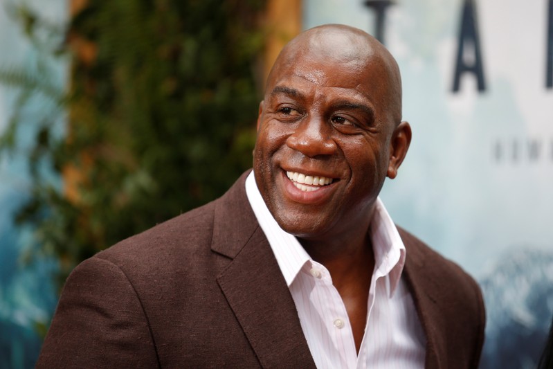 FILE PHOTO: Former NBA basketball player Earvin Magic Johnson poses at the premiere of the movie
