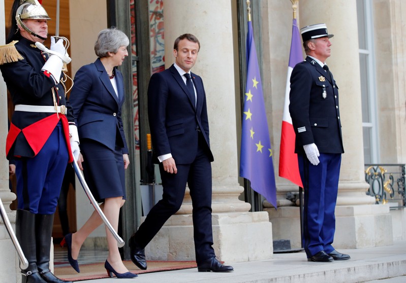 French President Emmanuel Macron and British Prime Minister Theresa May leave after a meeting to discuss Brexit, at the Elysee Palace in Paris