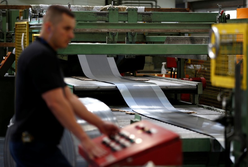 A worker at perforating company Bion uses a machine at the factory in Reading