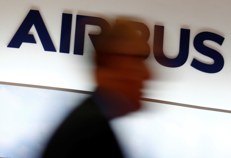 A man walks past an Airbus logo at the Langkawi International Maritime and Aerospace Exhibition in Langkawi