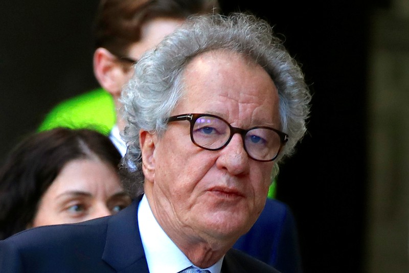 Australian actor Geoffrey Rush reacts as he arrives at the Federal Court in Sydney