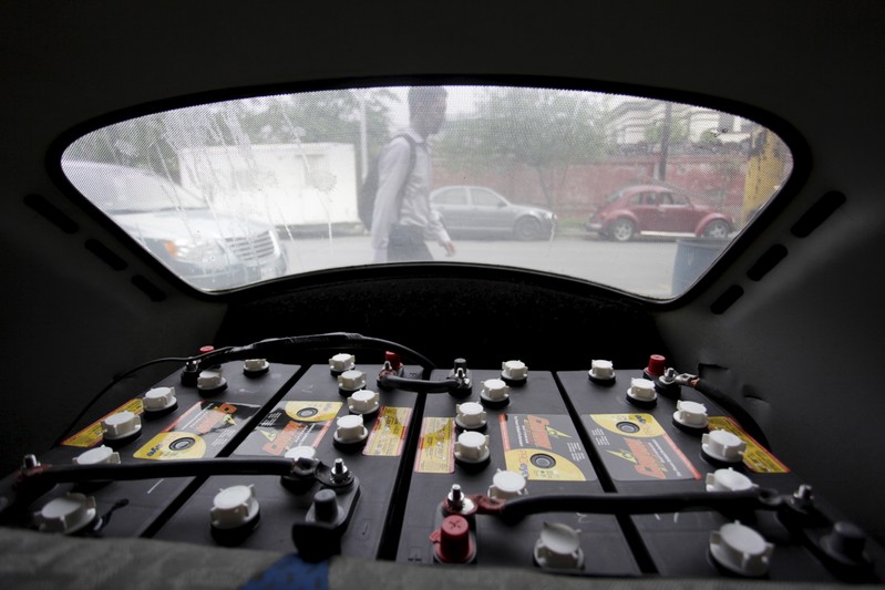 Batteries are seen in the engine compartment of a VW Beetle 1995, locally called