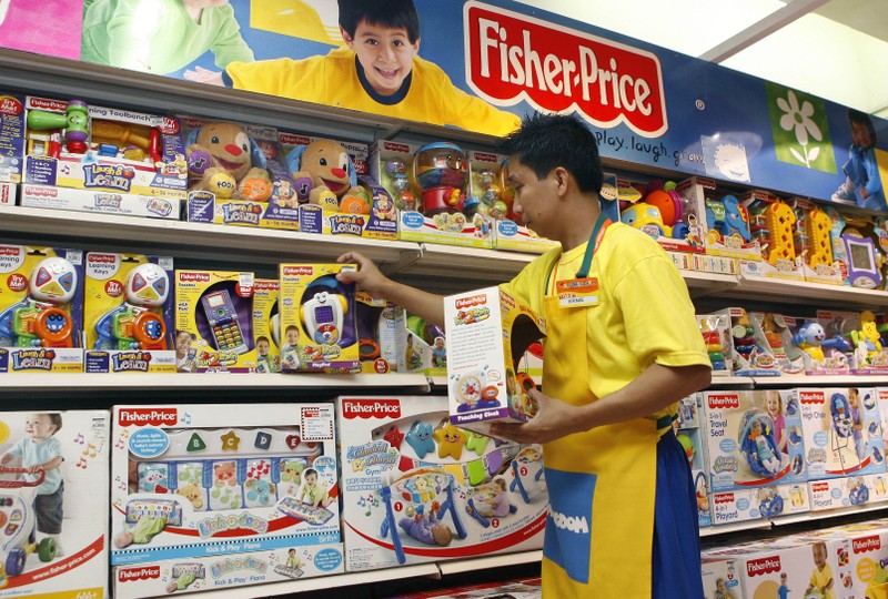 FILE PHOTO: An employee arranges Fisher-Price toys at a store in Manila's Makati financial district