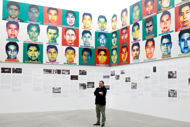 Chinese artist Ai Weiwei poses for photographers during a photocall for his exhibition