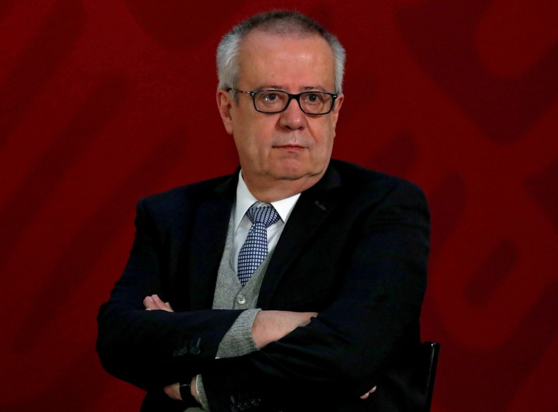 FILE PHOTO: Mexico's Finance Minister Carlos Urzua listens as President Andres Manuel Lopez Obrador speaks to the media during a news conference to announce a plan to strengthen finances of state oil firm Pemex, in Mexico City