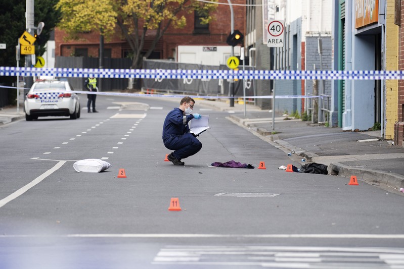 A Victoria Police personnel works at the scene of a multiple shooting outside Love Machine nightclub in Prahran, Melbourne