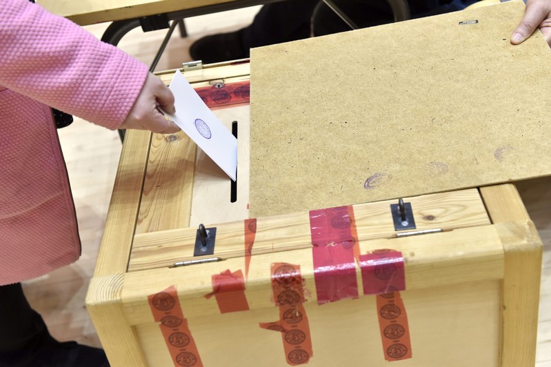 A voter casts her vote at Mantsala town hall during the Finnish parliamentary elections, in Mantsala