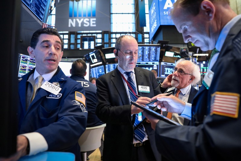 Traders work on the floor at the NYSE in New York