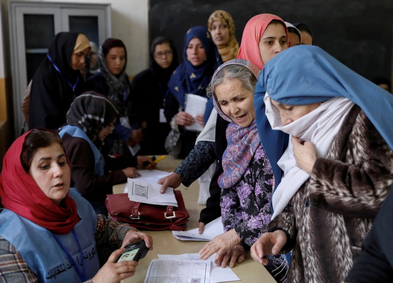 FILE PHOTO: Afghan women line up at a polling station during parliamentary elections in Kabul