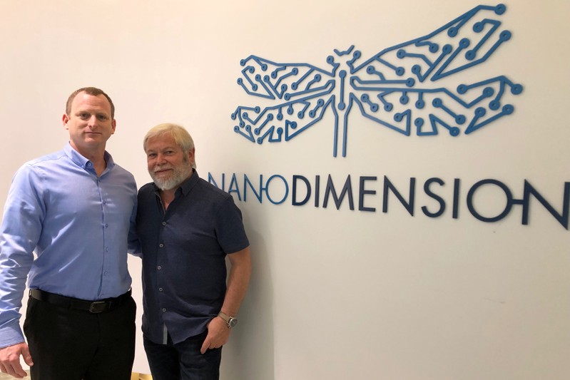 Israeli company Nano Dimension CEO Amit Dror and Chairman Avi Reichental, pose for a picture next to the company logo during an interview with Reuters in Ness Tziona, Israel