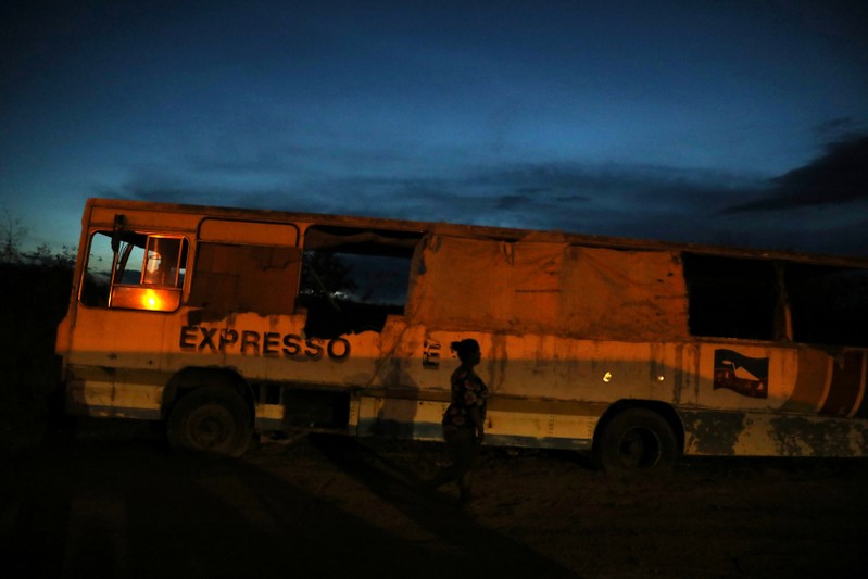 Belki Contreras walks around an abandoned bus at night in the border city of Pacaraima