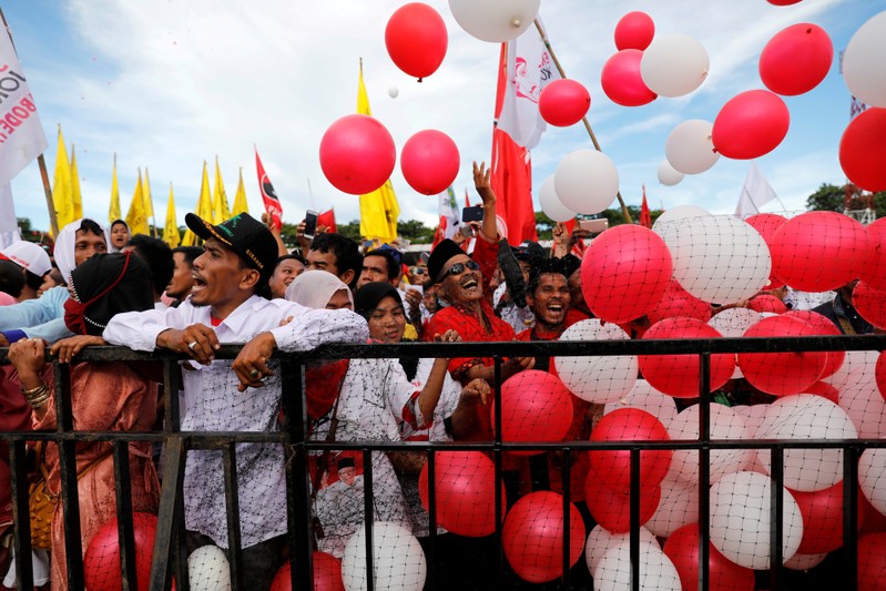 FILE PHOTO: Supporters throw balloons as they attend a campaign rally of Indonesia's presidential candidate for the next general election Joko Widodo at a stadium in Serang
