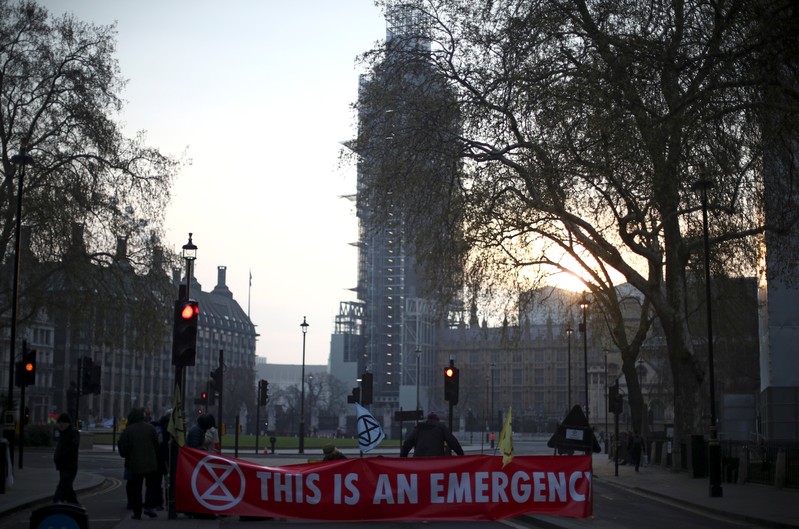 Climate change activists block a road during the Extinction Rebellion protest at Parliament Square in London