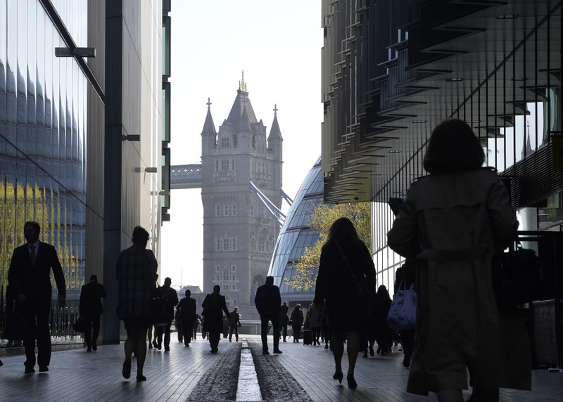 FILE PHOTO: City workers head to work during the morning rush hour in London