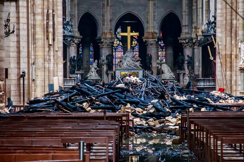 A view of the debris inside Notre-Dame de Paris in the aftermath of a fire that devastated the cathedral, during the visit of French Interior Minister Christophe Castaner, in Paris