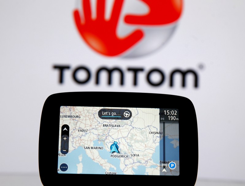 TomTom navigation are seen in front of TomTom displayed logo in this illustration taken