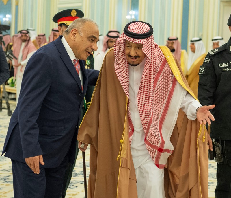 Saudi Arabia's King Salman bin Abdulaziz walks with Iraq's Prime Minister Adel Abdul Mahdi in Riyadh