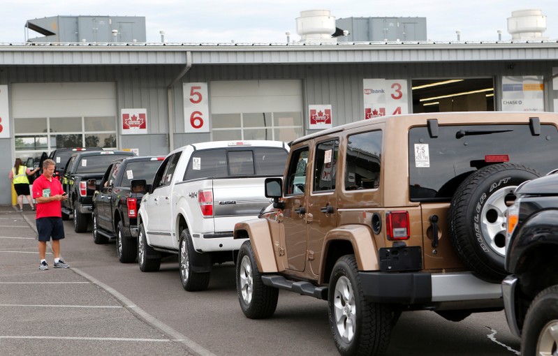 FILE PHOTO: Used vehicles are lined up in lanes before being sold during a dealer-only auction at Manheim Detroit auction house in Carleton, Michigan