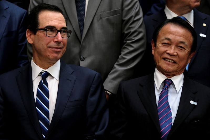 FILE PHOTO: U.S. Treasury Secretary Steven Mnuchin and Japanese Finance Minister Taro Aso attend the IMF and World Bank's 2019 Annual Spring Meetings, in Washington