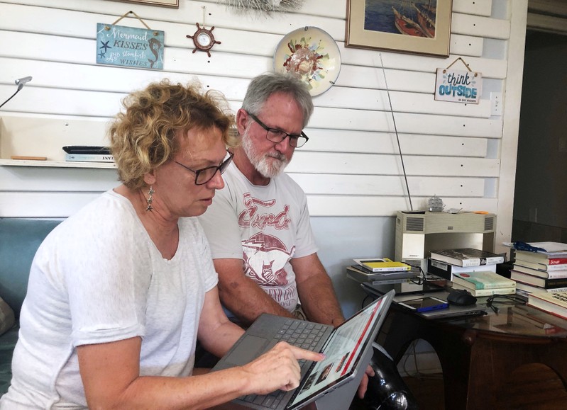 Eileen O’Brien and Michael O’Brien read the redacted report by U.S. Special Counsel Robert Mueller on Russian interference in the 2016 U.S. presidential election in Clearwater