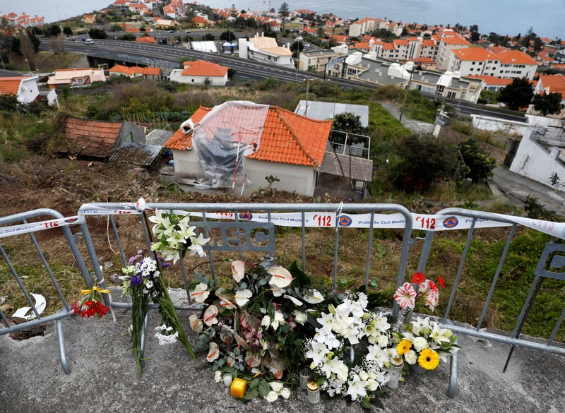 Flowers are seen at the site of a bus accident in Canico