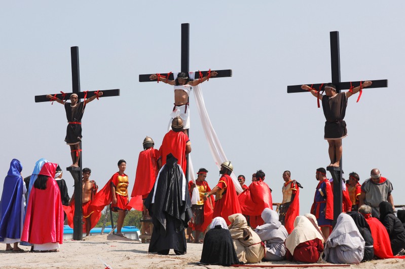 Filipino devotees are nailed on wooden crosses during a crucifixion re-enactment on Good Friday, in San Fernando City