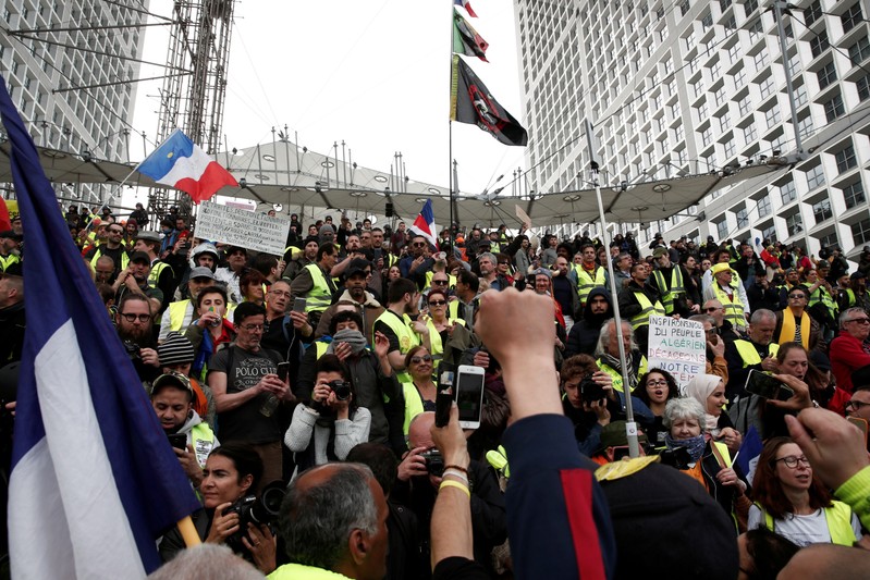 FILE PHOTO: Protesters wearing yellow vests attend a demonstration during the Act XXI (the 21st consecutive national protest on Saturday) of the yellow vests movement at the financial district of La Defense near Paris