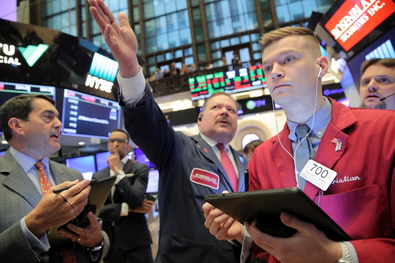 Traders work on the floor at the NYSE in New York