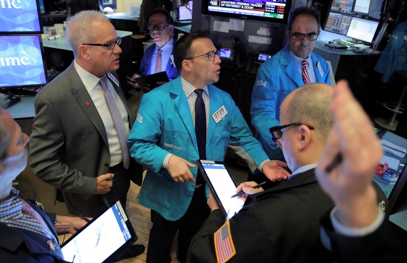 Traders work on the floor at the NYSE in New York