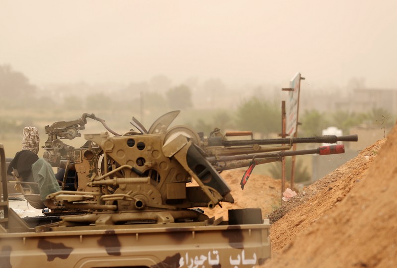 Members of the Libyan internationally recognised government forces take position during the fighting with the Eastern forces in Ain Zara, in Tripoli