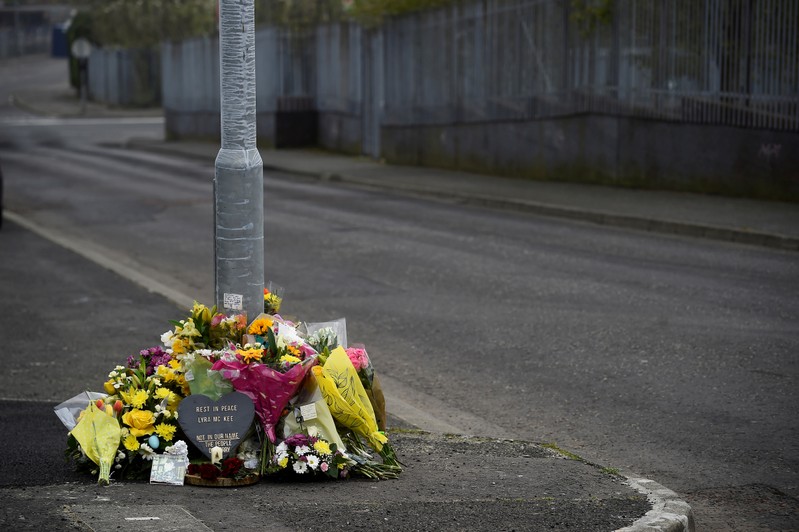 Flowers and a candle are left at the exact spot where 29-year-old journalist Lyra McKee was shot dead, in Londonderry