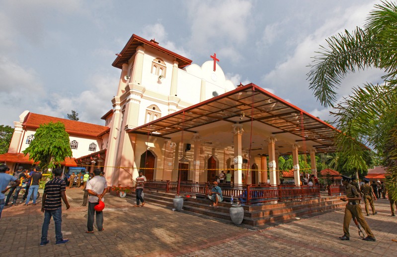 Security personnel stand guard outside a church after a bomb blast in Negombo