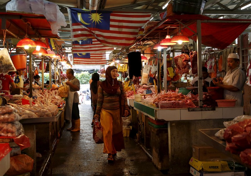 FILE PHOTO: A woman shops in a wet market in Kuala Lumpur