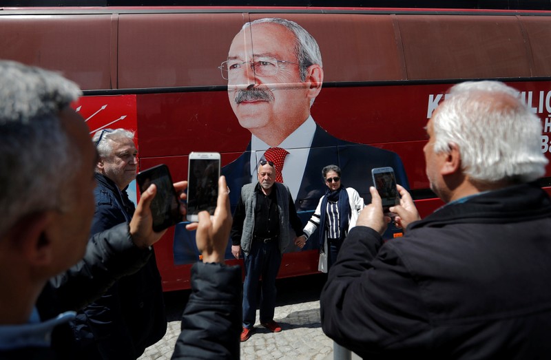 Supporters of the main opposition CHP pose in front of a party bus with a picture of their leader Kemal Kilicdaroglu on it, in Istanbul