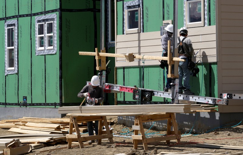 Workers construct a new home in Leyden Rock in Arvada, Colorado