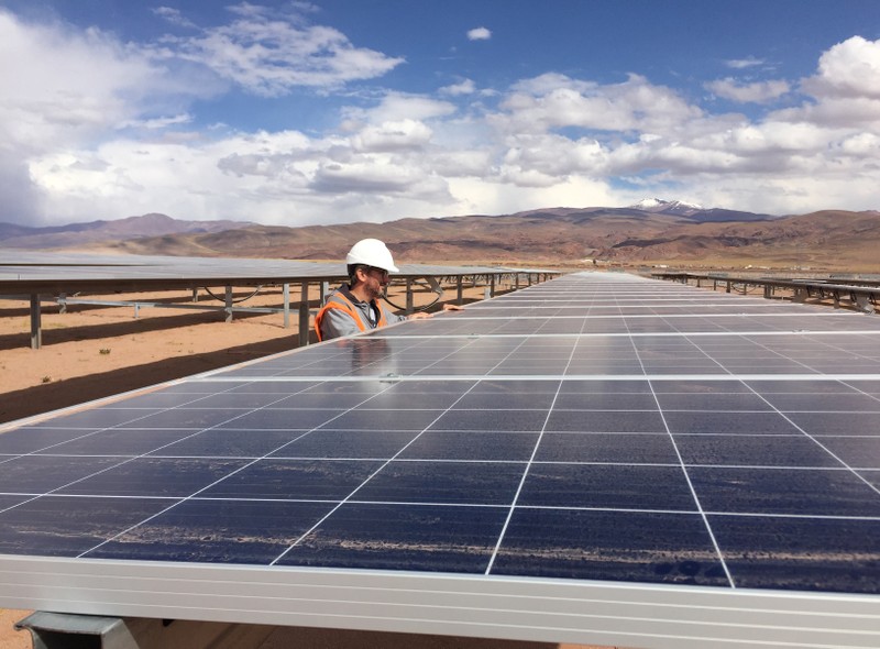 Guillermo Giralt, technical director of Cauchari Solar, stands next to solar panels at a solar farm, built on the back of funding and technology from China, in Salar de Cauchari