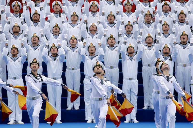 Chinese navy personnel perform at an event celebrating the 70th anniversary of the founding of the Chinese People's Liberation Army Navy (PLAN) in Qingdao