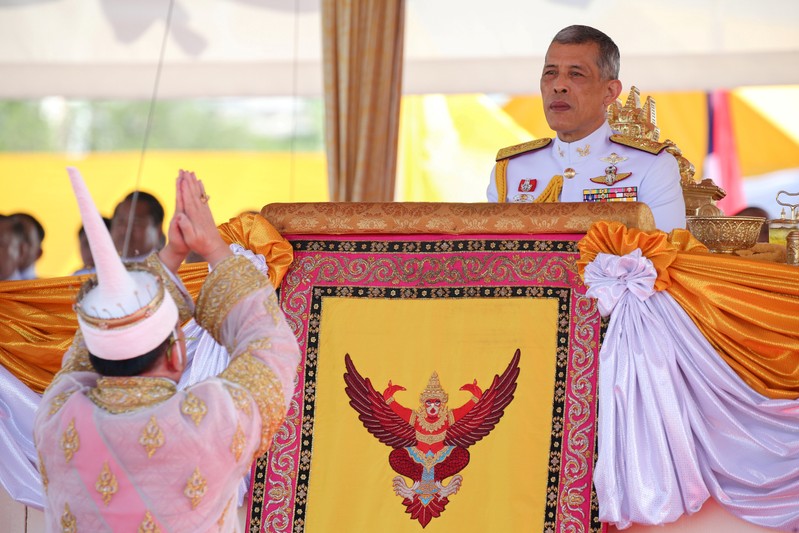 Lertviroj Kowattana, permanent secretary of the Thai Ministry of Agriculture and Cooperatives, dressed in a traditional costume, greets Thailand's King Maha Vajiralongkorn during the annual Royal Ploughing Ceremony in central Bangkok