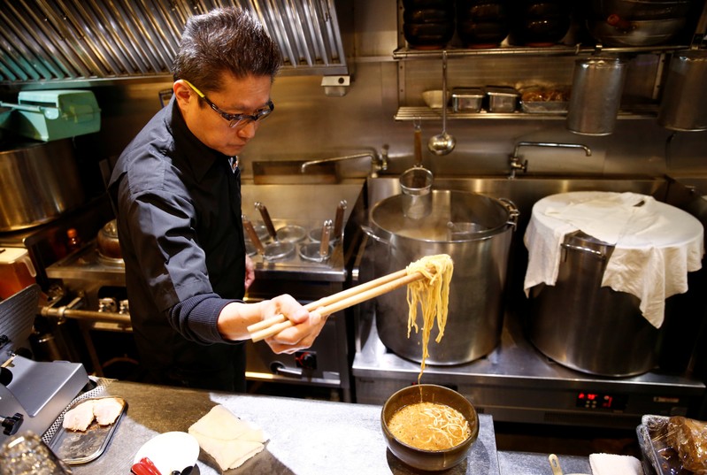 Kenji Saito cooks at his ramen noodle shop in Tokyo