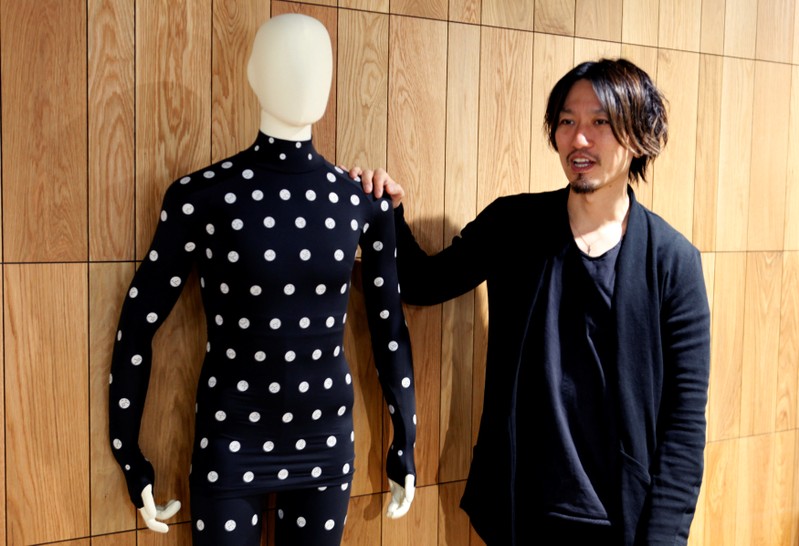 Yuki Kanayama, Chief Innovation Officer of Zozo Technologies, poses with a Zozosuit after an interview with Reuters in Tokyo
