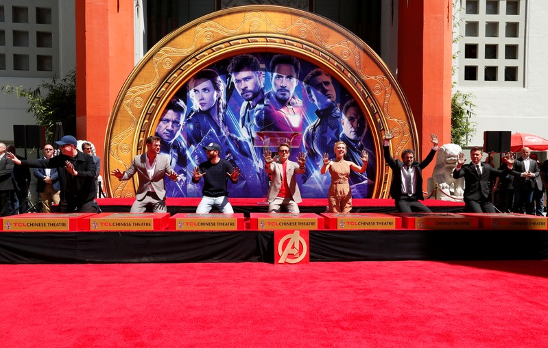 Actors Robert Downey Jr., Chris Evans, Mark Ruffalo, Chris Hemsworth, Scarlett Johansson, Jeremy Renner and Marvel Studios President Kevin Feige place their handprints in cement at a ceremony at the TCL Chinese Theatre in Hollywood