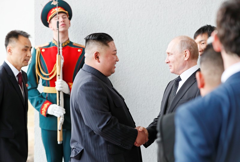 Russia's President Vladimir Putin shakes hands with North Korea leader Kim Jong Un at the Far Eastern Federal University campus at Russky Island in the far eastern city of Vladivostok, Russia